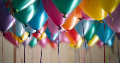 selective focus photography of assorted-color balloons