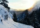 the sun is shining through the clouds over the mountains