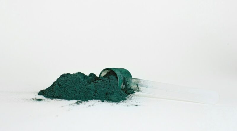 a green bug on a white surface