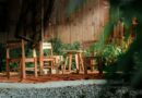 a couple of wooden chairs sitting on top of a wooden deck