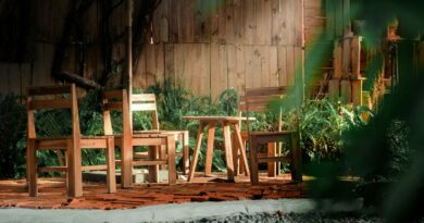 a couple of wooden chairs sitting on top of a wooden deck