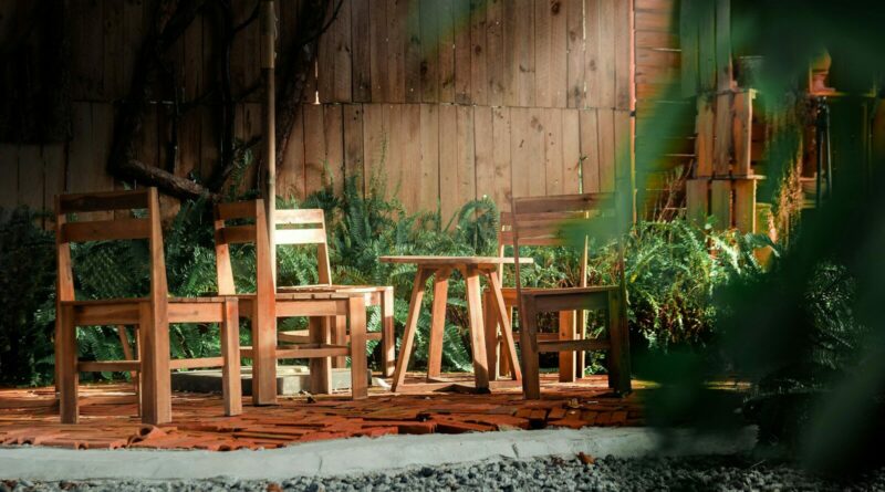 a couple of wooden chairs sitting on top of a wooden deck